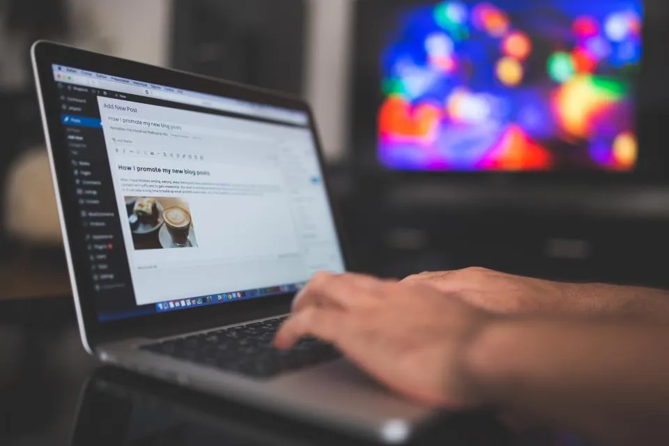 Person writing a blog post in WordPress on a laptop
